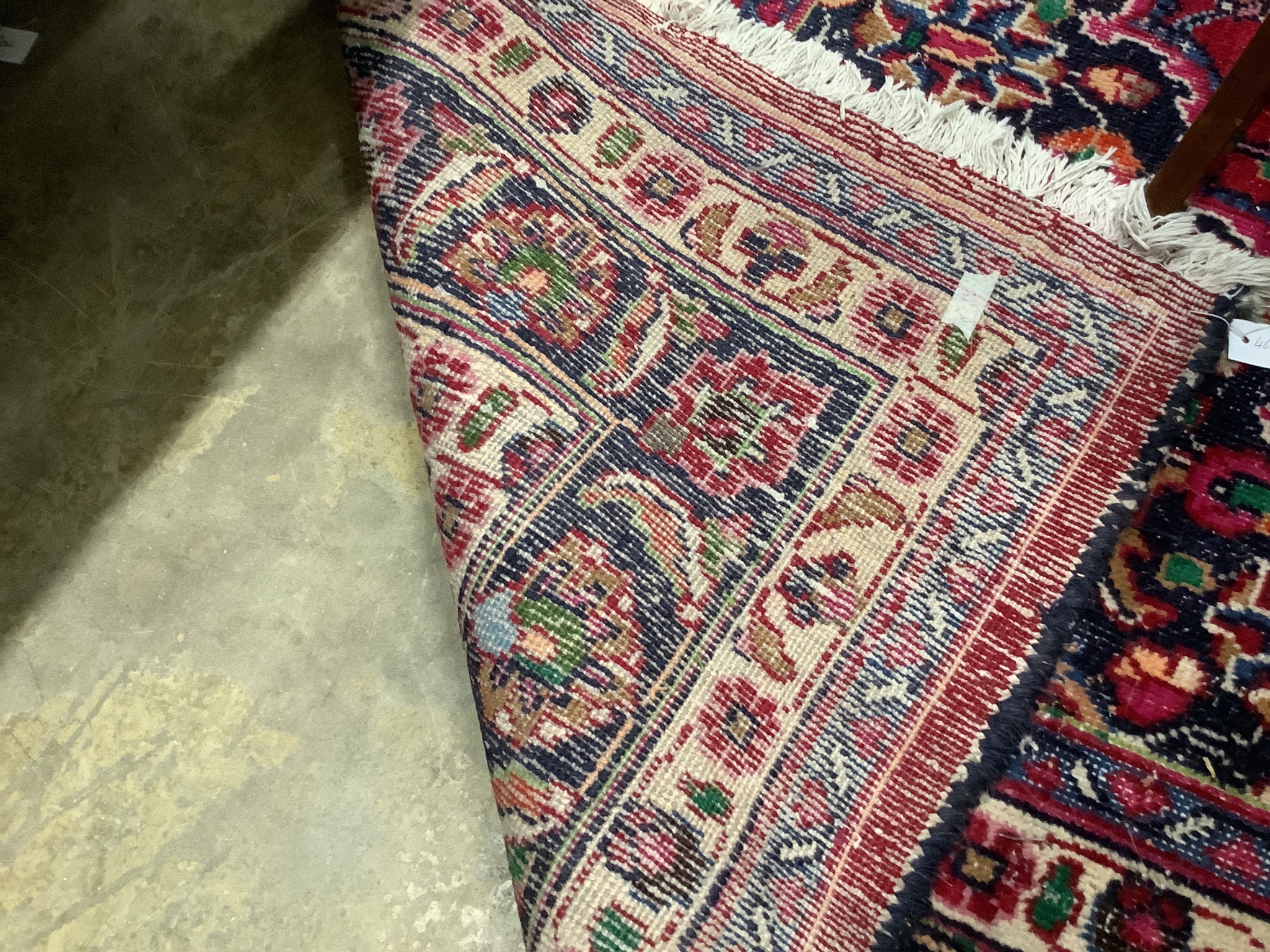 A Heriz style burgundy ground carpet, 380 x 360cm